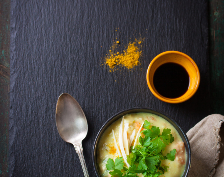 Tasty homemade curry soup with chicken and vegetables, top view with copy space